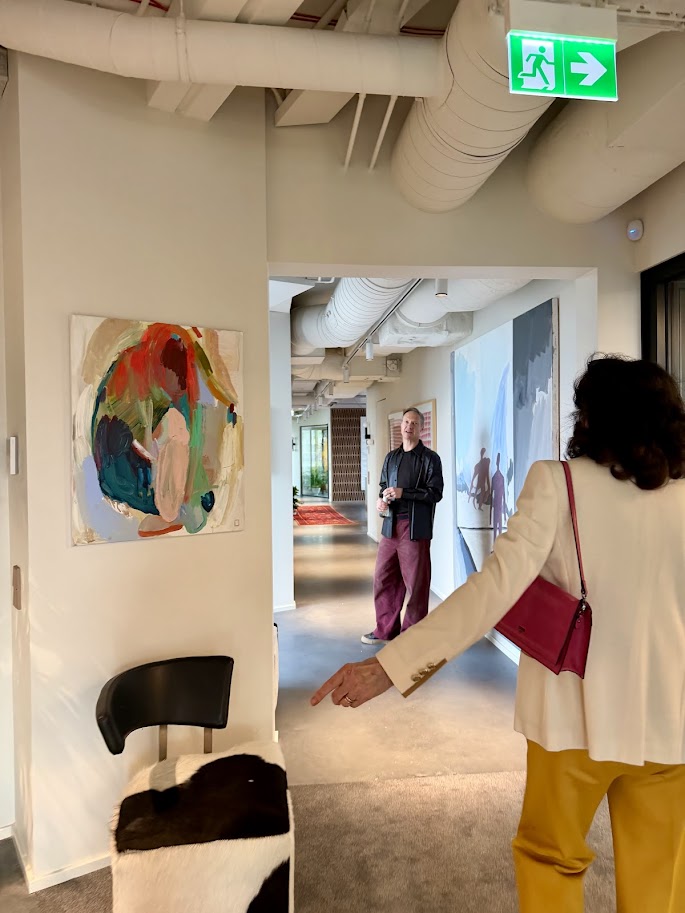 Colorful circular abstract painting in contemporary office hallway